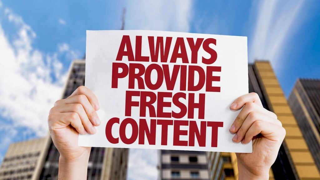 One-Dog-Solutions-Content-SEO-Guide-16x9 Hands holding sign promoting fresh content creation