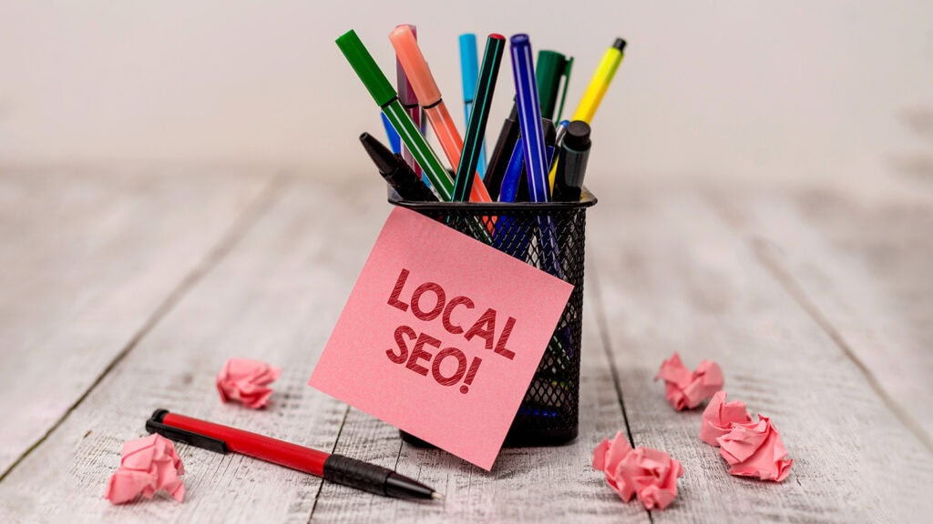 Conceptual hand writing showing Local Seo. Business photo text incredibly effective way to market your near business online Writing equipment and paper scrap with blank sheets on wooden desk. Local SEO note on desk with pens