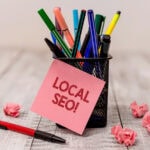 Local SEO note on desk with pens
